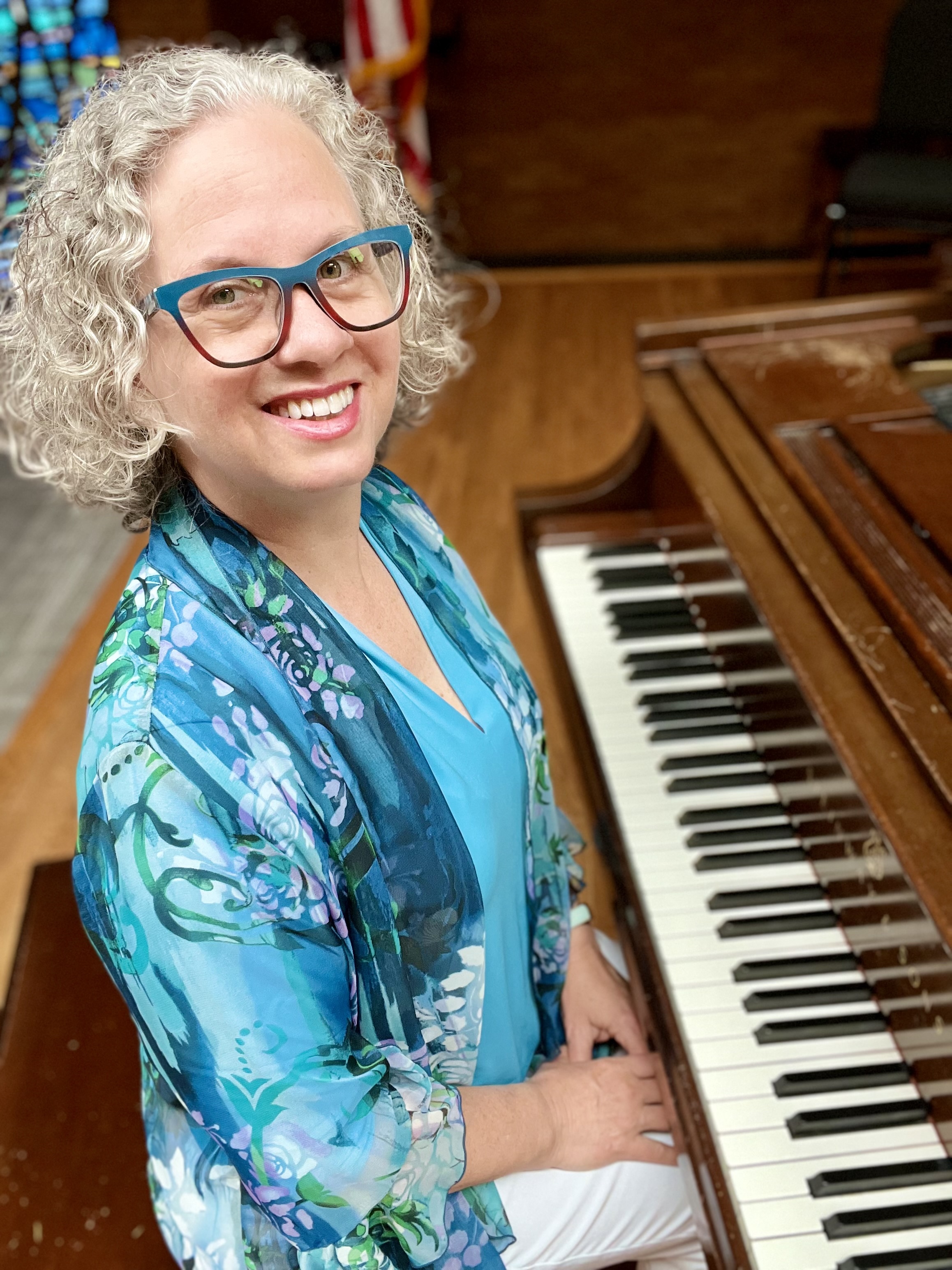author, poet, musician, podcast host, course creator Jenny Leigh Hodgins at the piano.